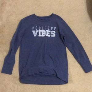Woman’s “positive vibes” sweatshirt